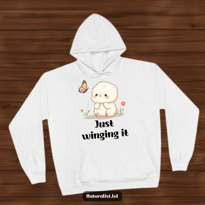 Funny hoodie featuring a fluffy creature observing a butterfly with pure fascination, evoking lightheartedness, an excellent funny gift.