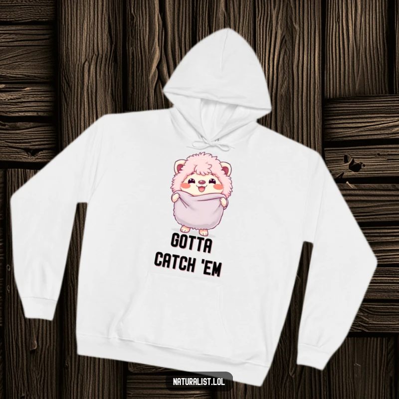 Funny hoodie featuring a fluffy creature grinning widely while holding a butterfly net, embodying playful enthusiasm, an excellent funny gift.